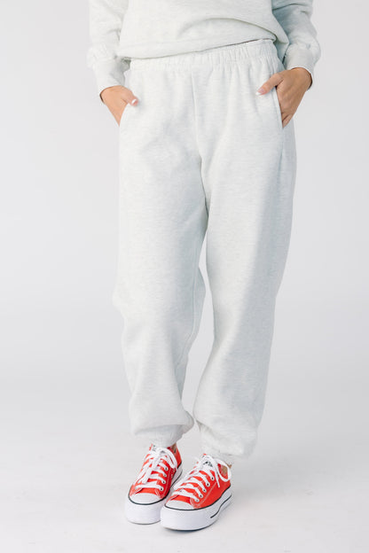 Woman wearing a pair of classic heather grey sweat pants