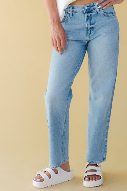 Woman wearing straight leg jeans in light denim.