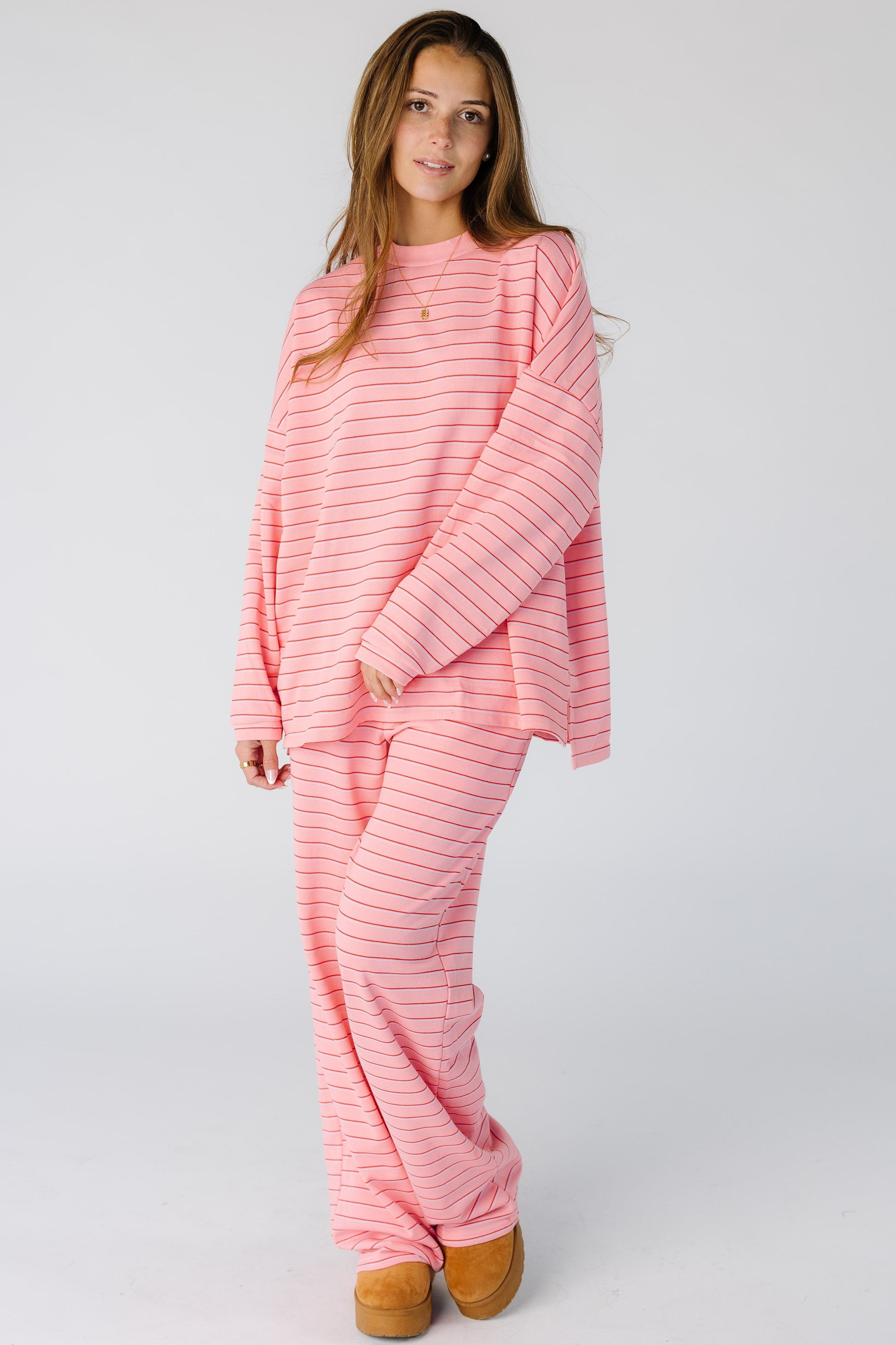 Woman wearing a soft stripe lounge set in pink 2 piece set