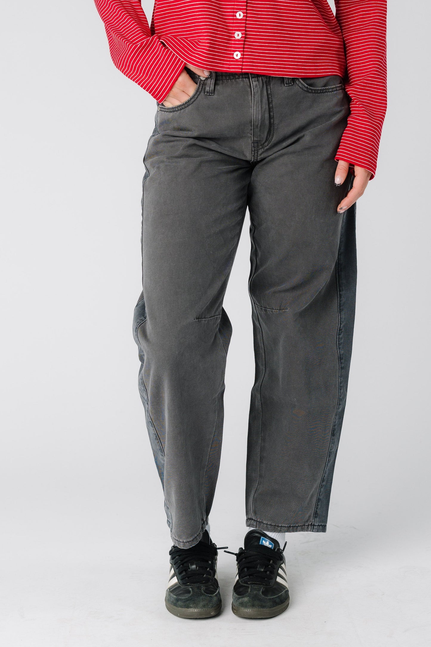 Woman wearing a pair of grey wide leg barrel jean