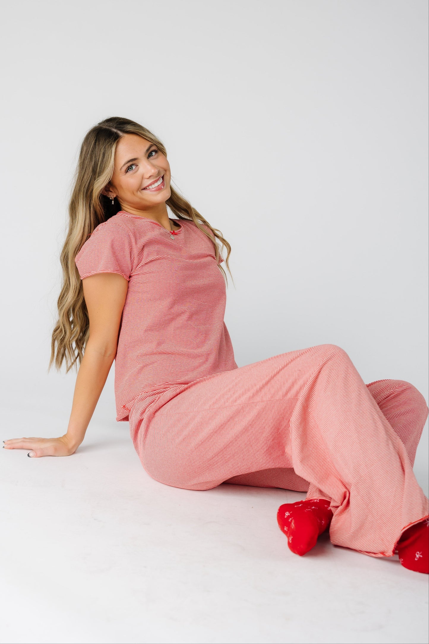 Woman wearing a short sleeve pajama set in red & white stripe