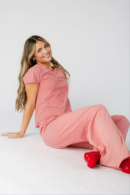 Woman wearing a short sleeve pajama set in red & white stripe