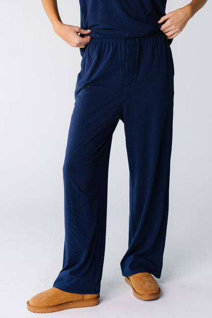 Close view of a woman wearing a pair of navy lounge pants with elastic waist