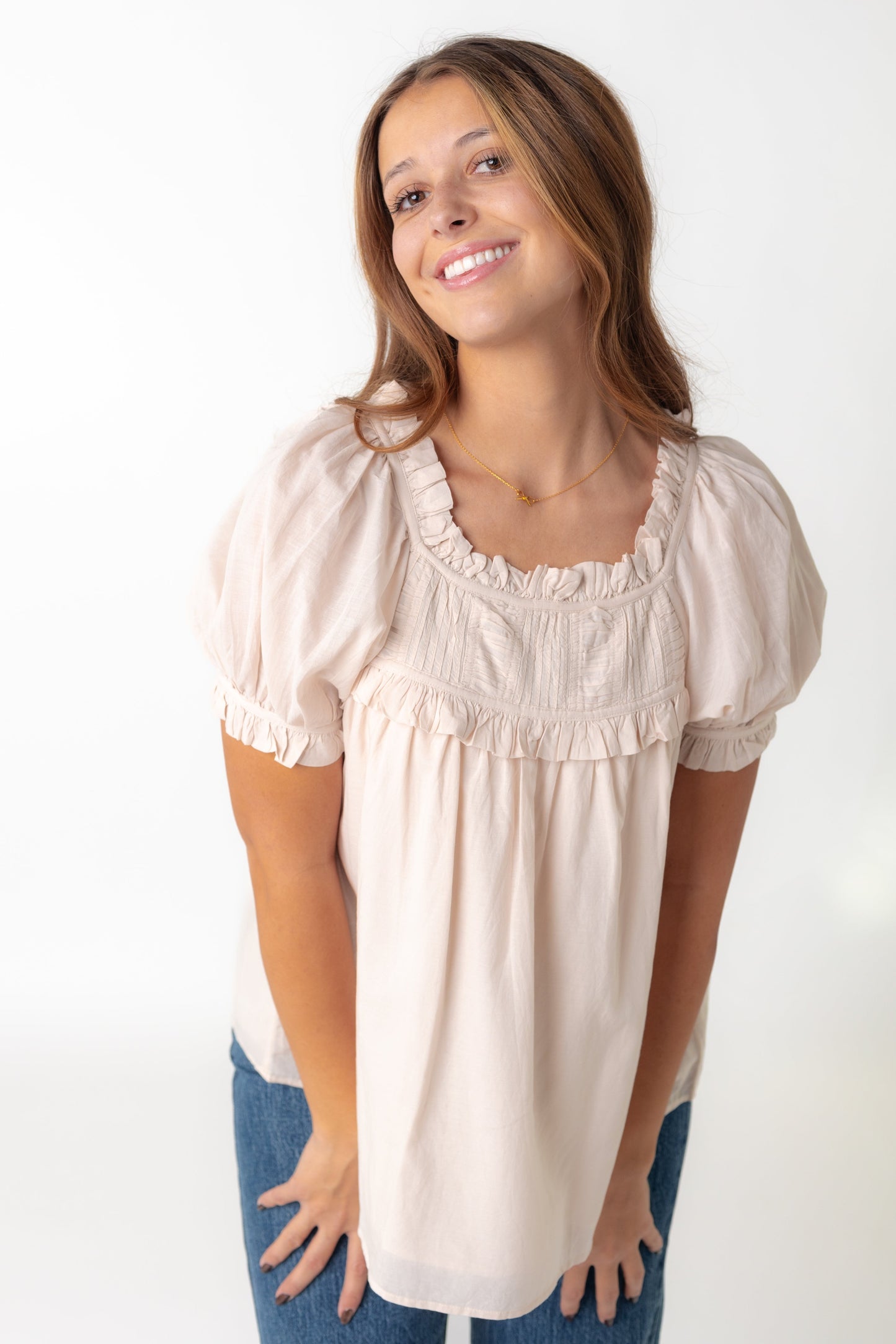 Beige short puff sleeve top with ruffles and pleated yoke
