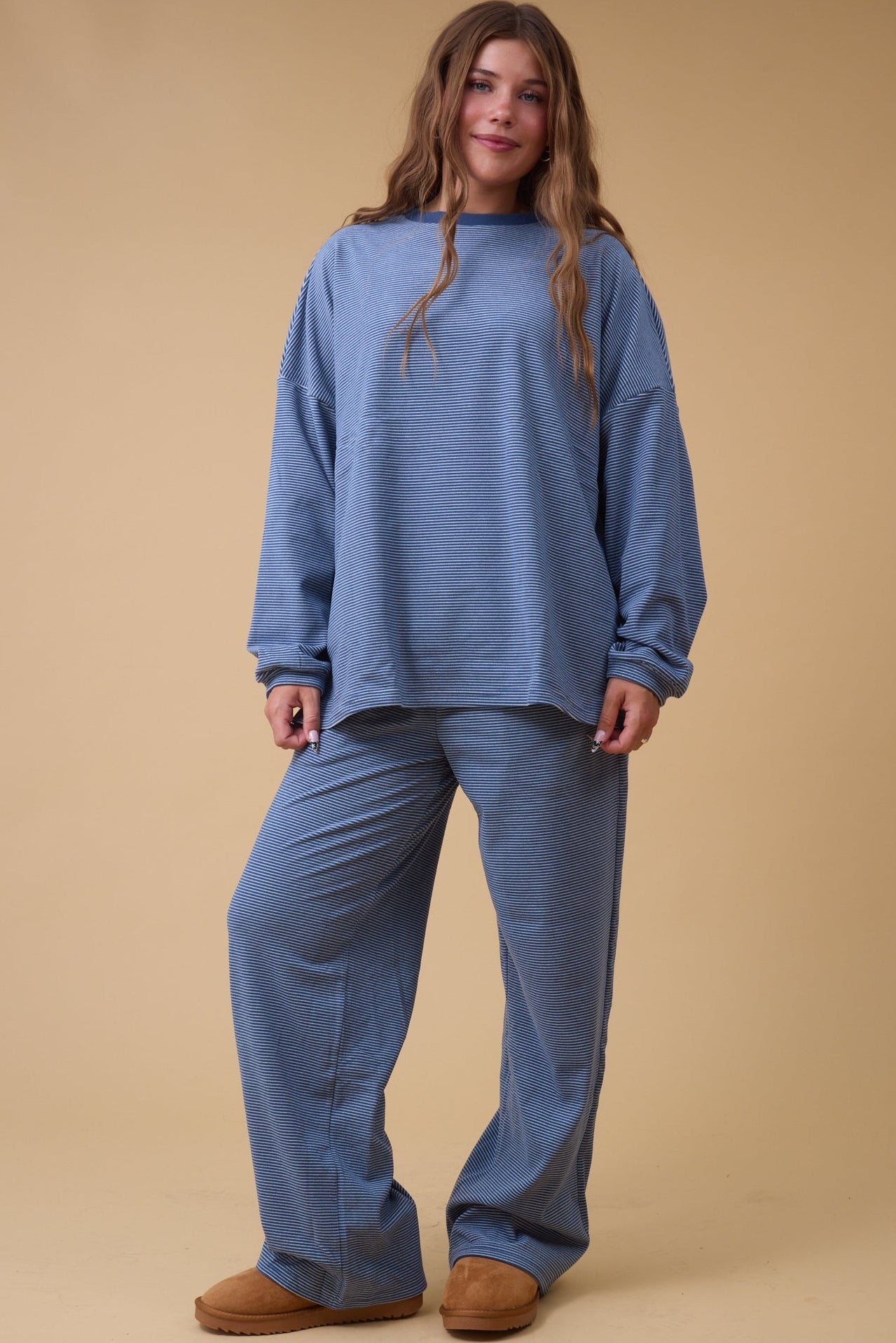 Woman wearing a blue stripe loose fitting lounge set.