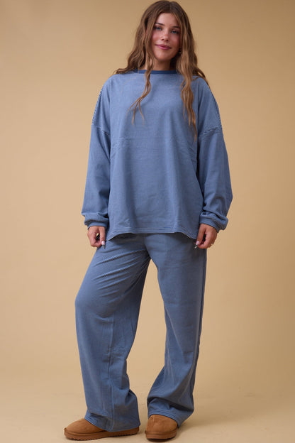 Woman wearing a blue stripe loose fitting lounge set.