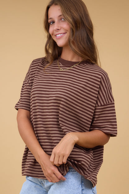 Young woman wearing a modest brown & tan stripe, short sleeve tee with a crew neckline.