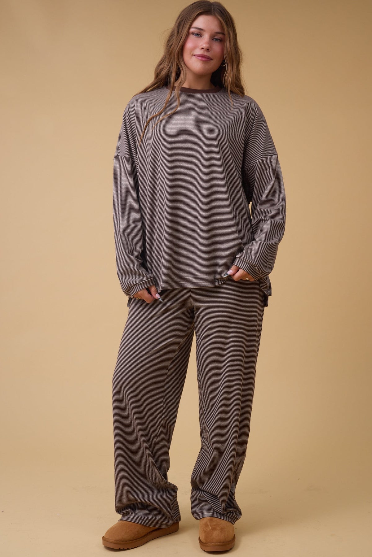 Woman wearing a brown stripe loose fitting lounge set.