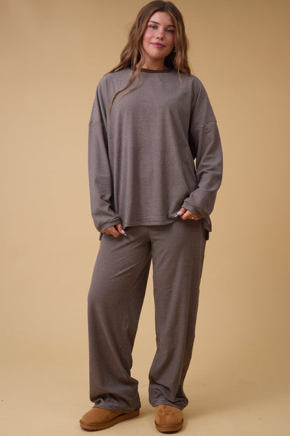 Woman wearing a brown stripe loose fitting lounge set.