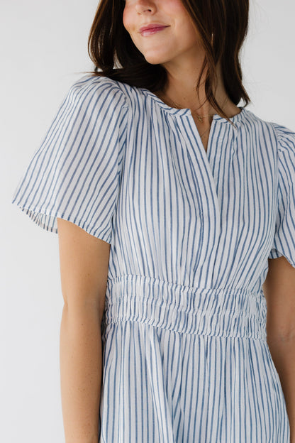 Closer view of a white and blue stripe dress with short sleeves.