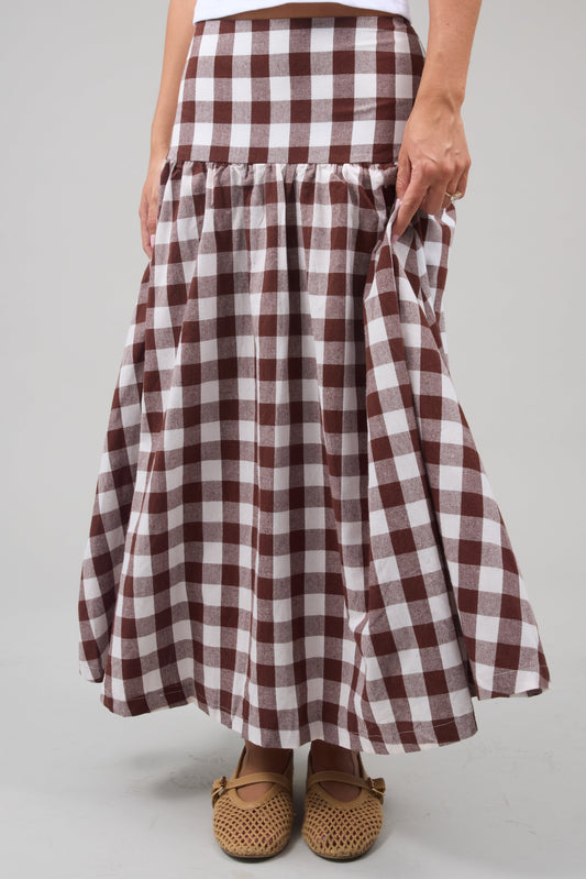 Young woman wearing a modest drop waist midi skirt in a large brown & white gingham.