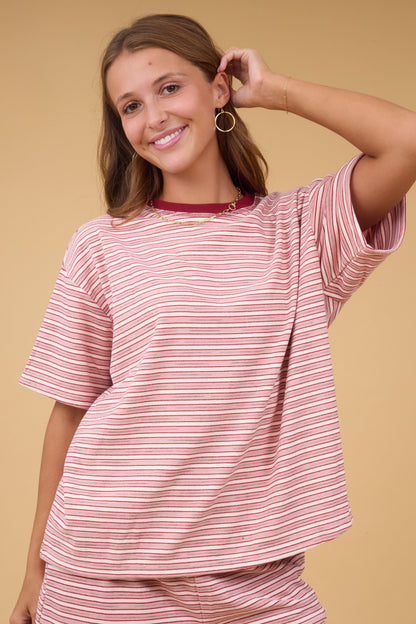 Young woman wearing a modest short sleeve plush knit stripe top with a crew neckline.