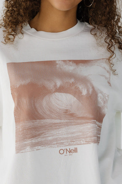 Close view of a woman wearing a large brown front wave graphic. 