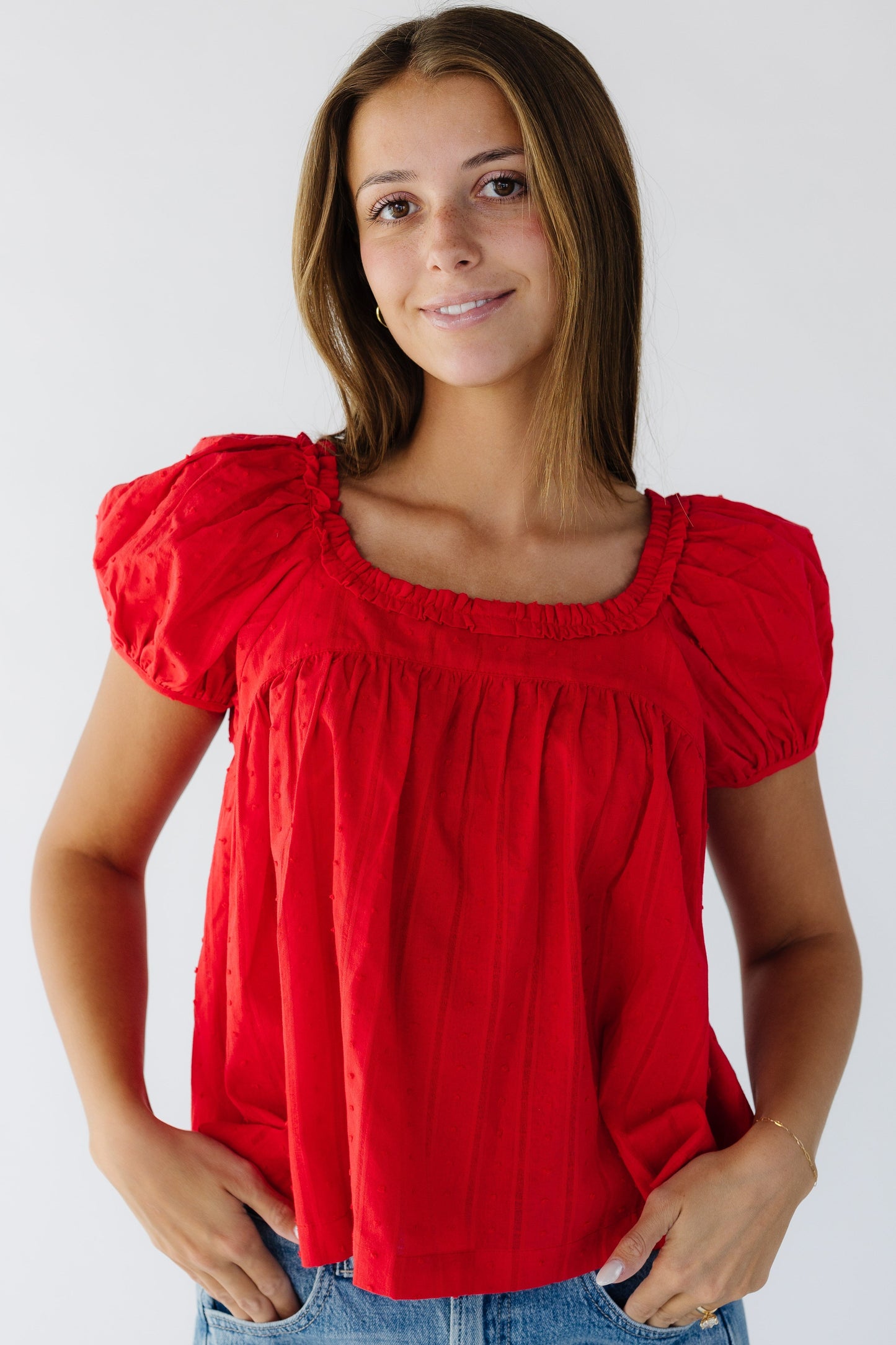 The Stadium Ruffle Top in red Swiss dot for women and teen girls.