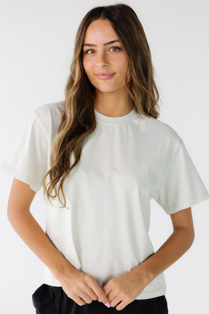 Woman wearing a modest crew neck tee with short sleeves and a boxy cut.
