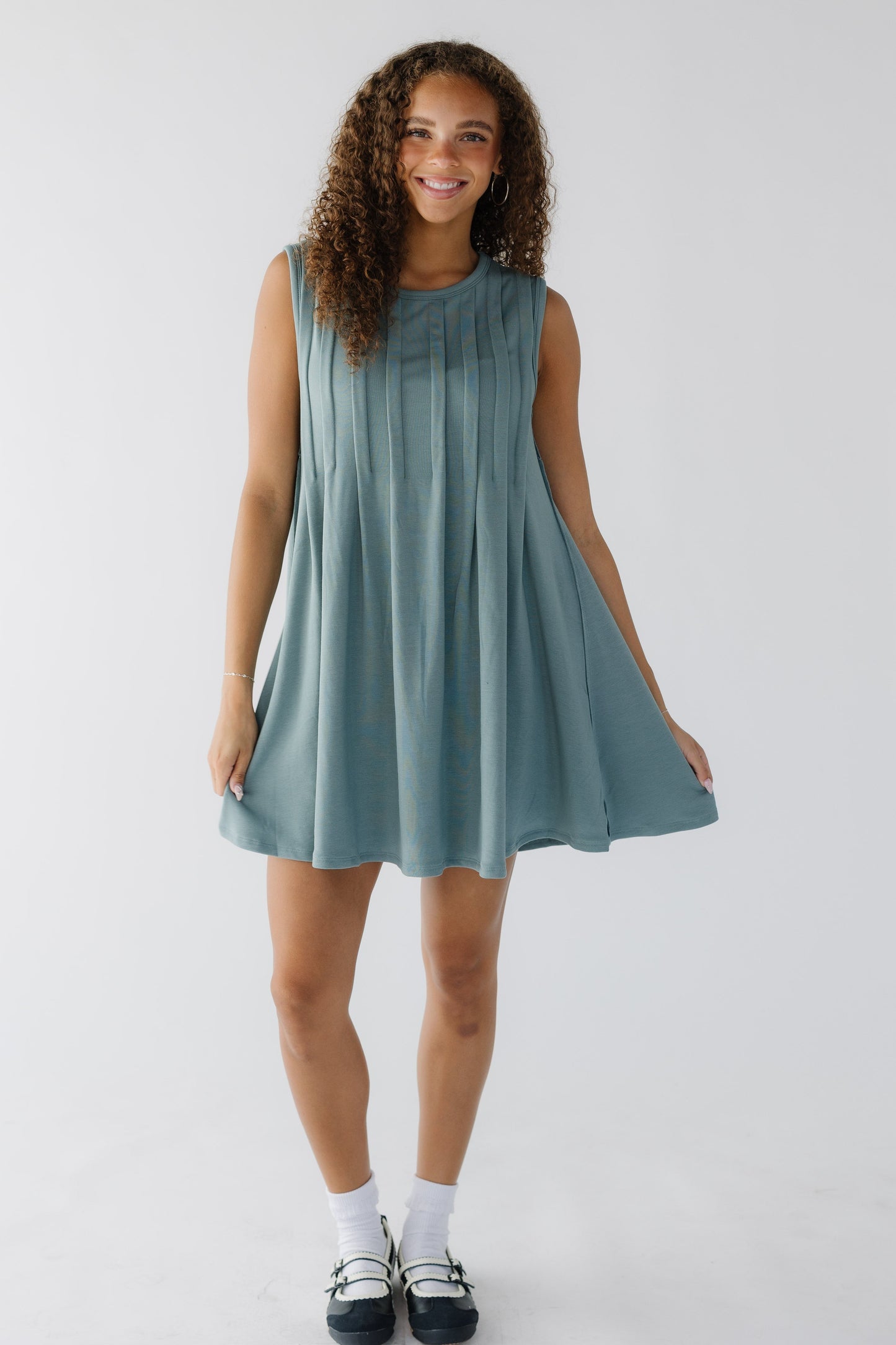 Aura Pleated Front Mini Dress in sage for women and teenage girls.
