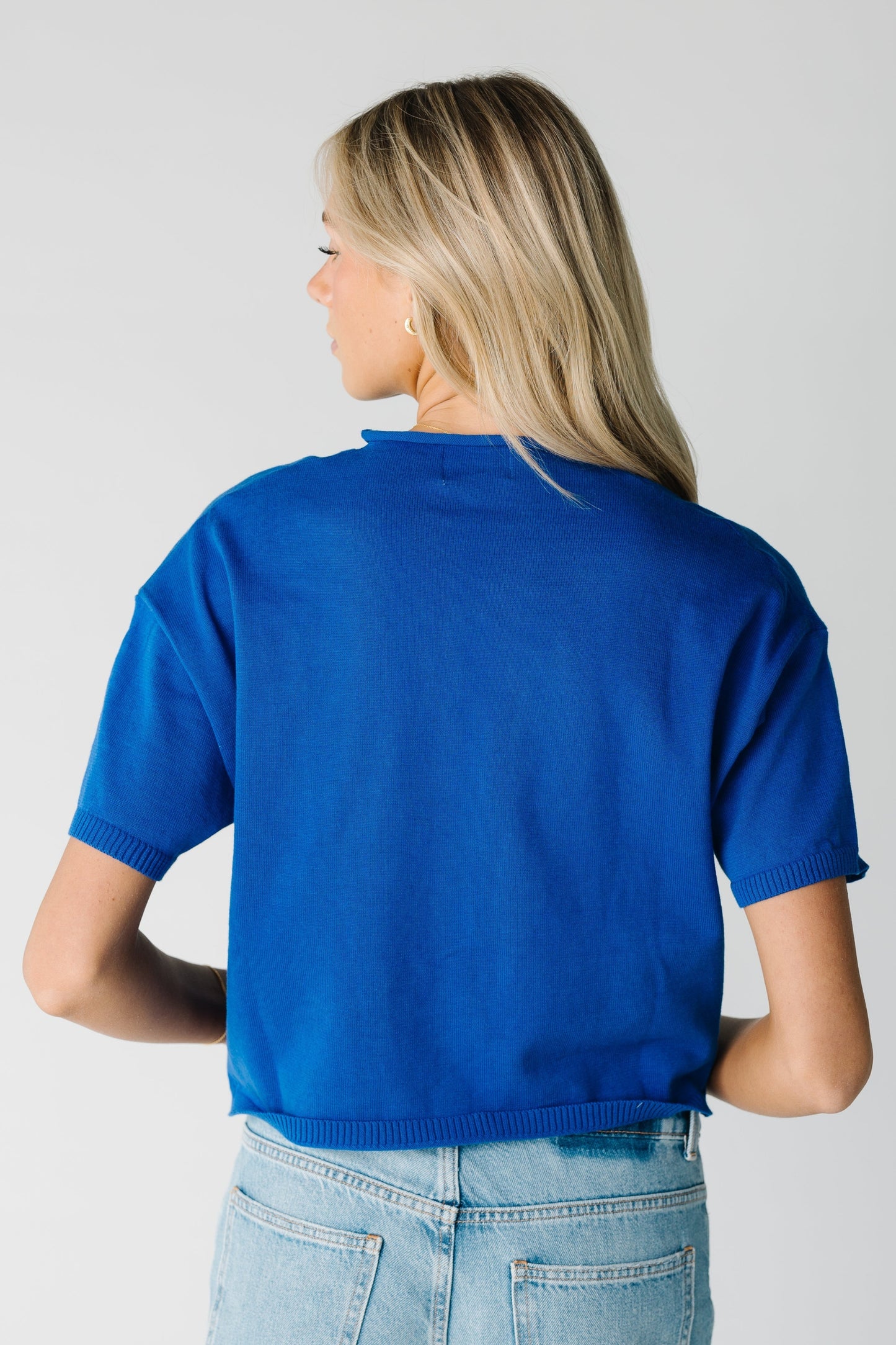 Back view of women's blue short sleeve top