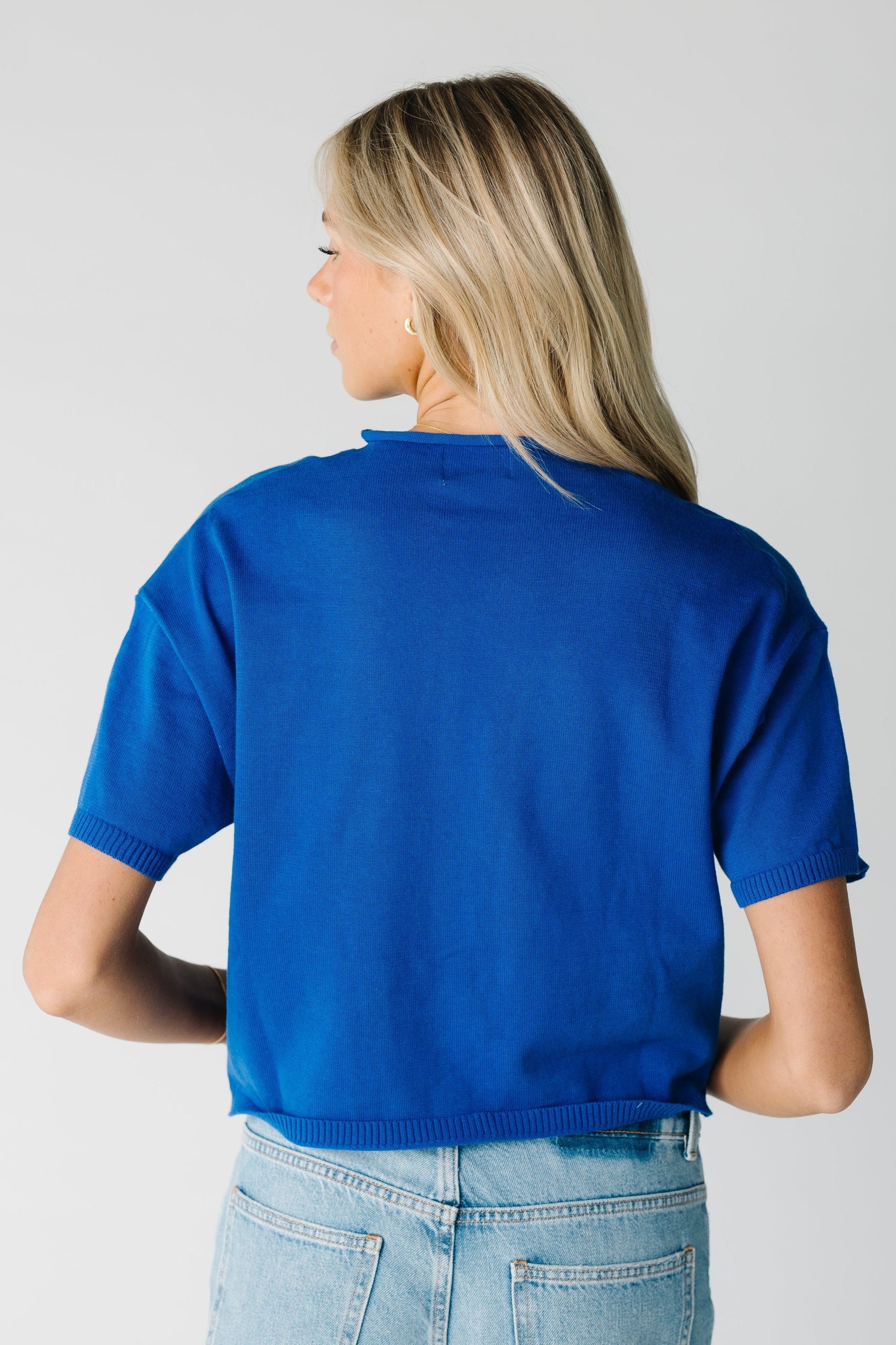 Back view of women's blue short sleeve top
