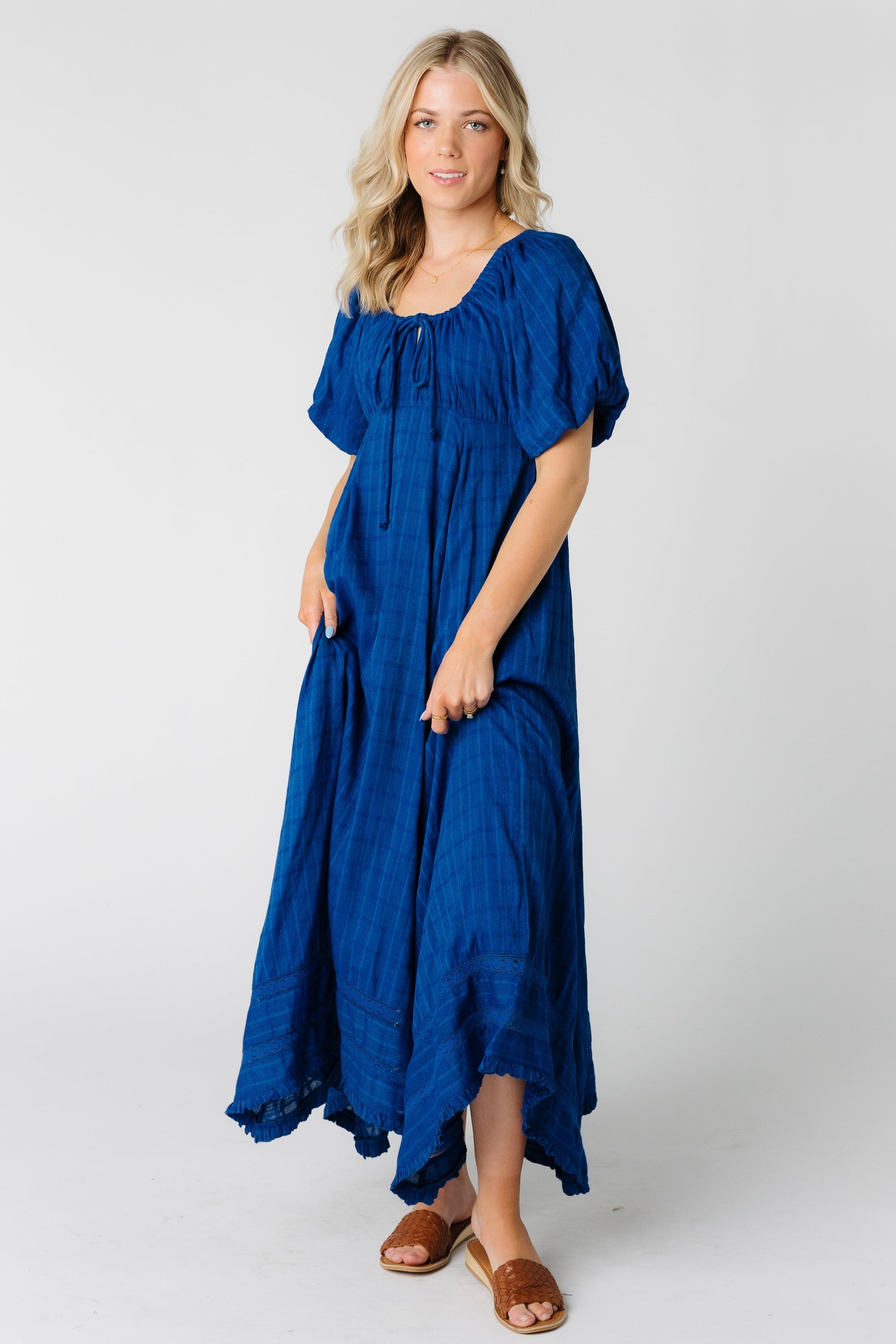 Woman wearing a blue maxi dress with scoop neckline