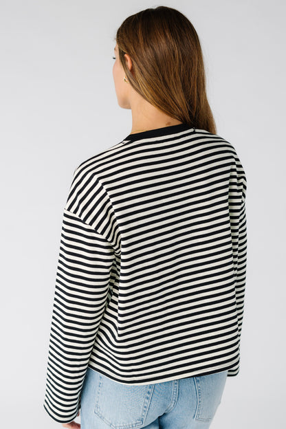 Back view of a woman wearing a black and white stripe tee with long sleeves