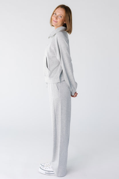 Side view of a woman wearing a heather grey lounge set with long sleeves and wide cut leg