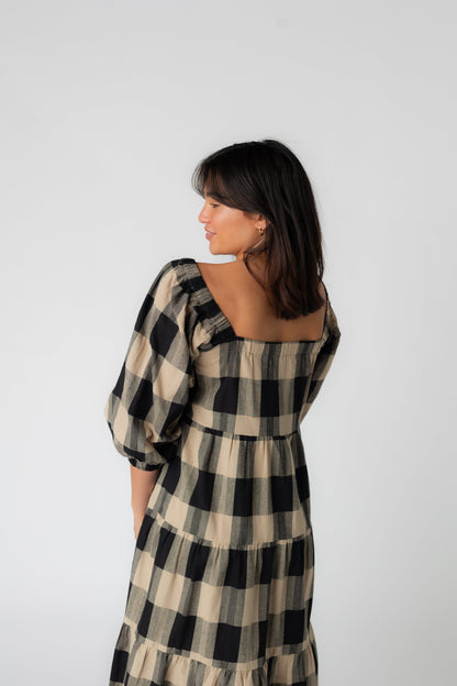 Back view of plaid dress with square neckline and half length sleeves