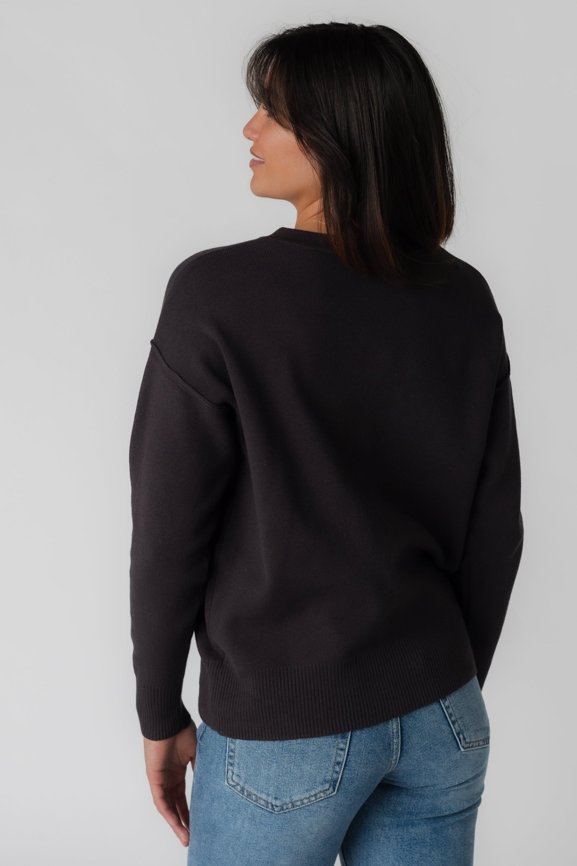 Back view of charcoal long sleeve sweater