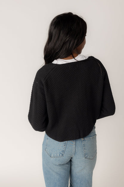 Back view of black long sleeve cardigan