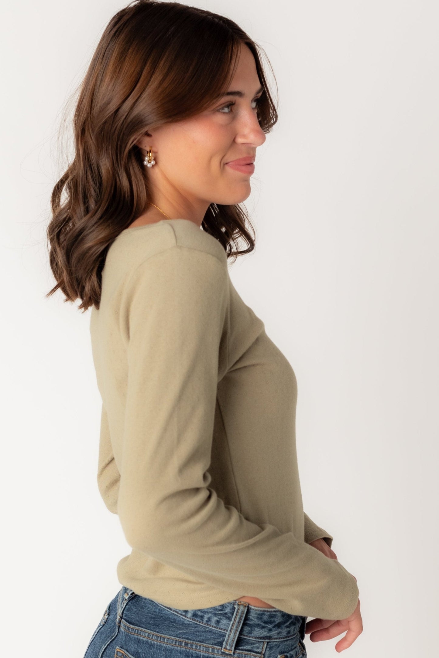 Side view of long sleeve pointelle top in olive