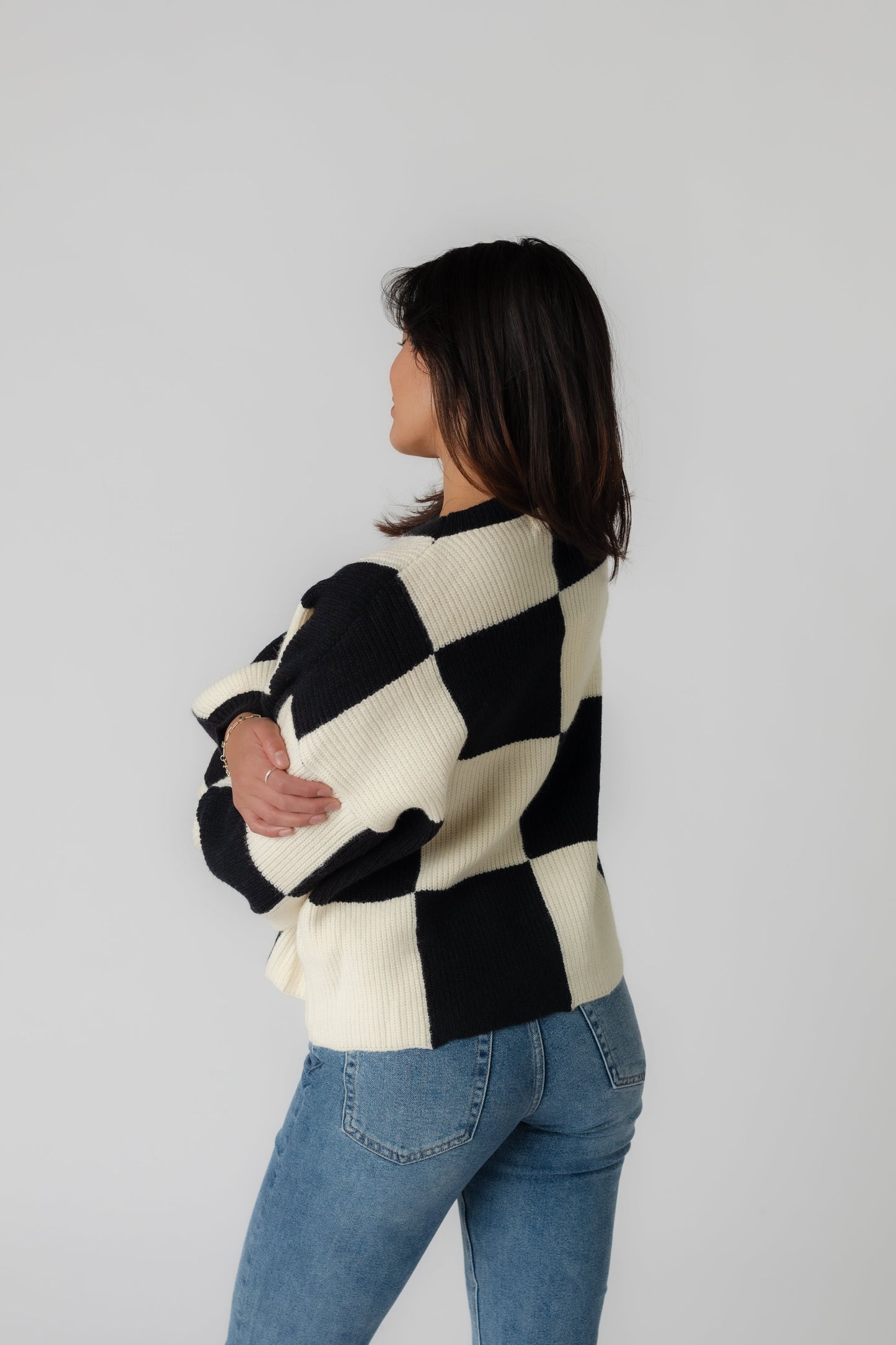 Back view of Mandy black checker sweater