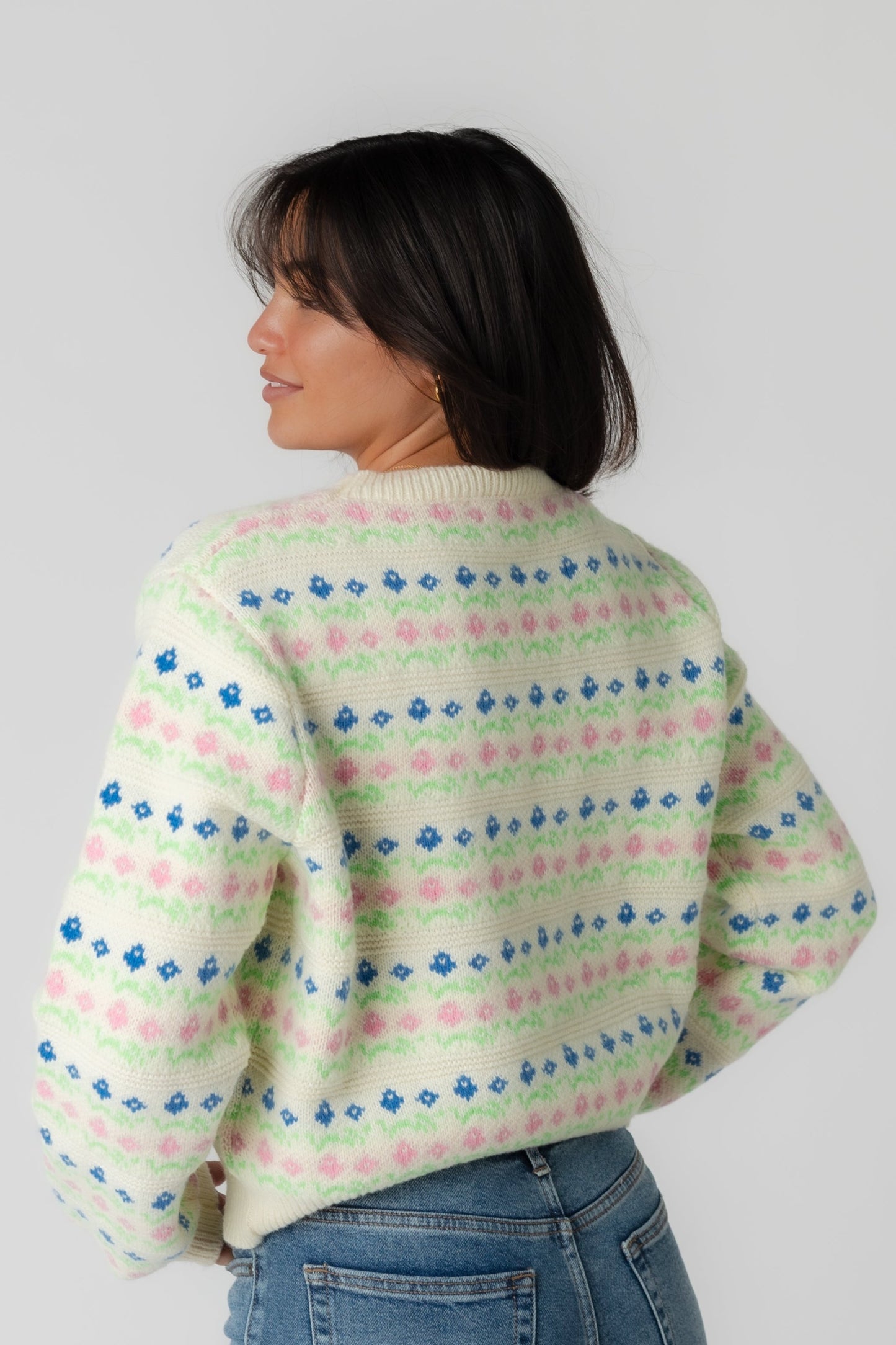 Back view of cream patterned sweater with long sleeves and crew neckline