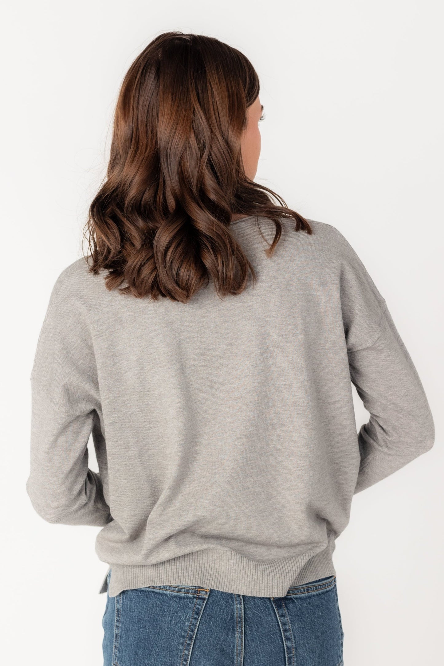 Back view of heather grey long sleeve sweater