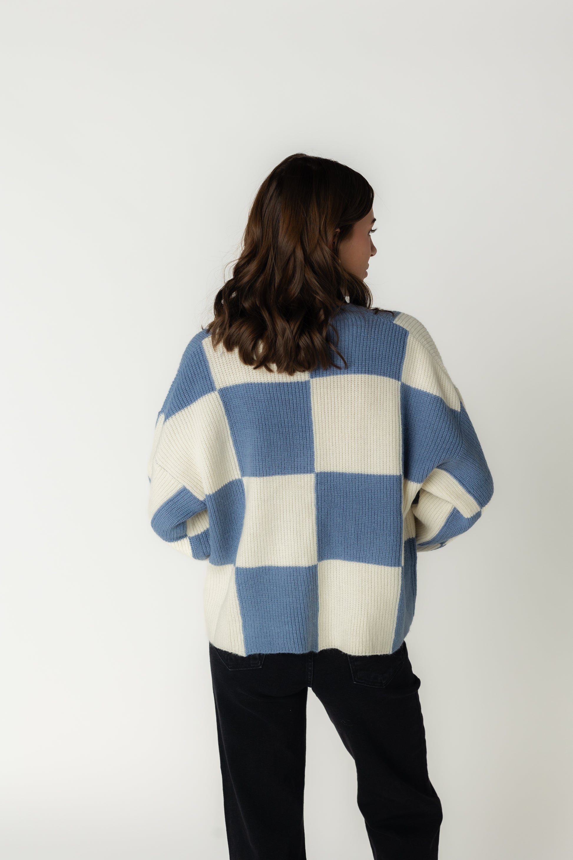 Back view of light blue and white bold  checker sweater