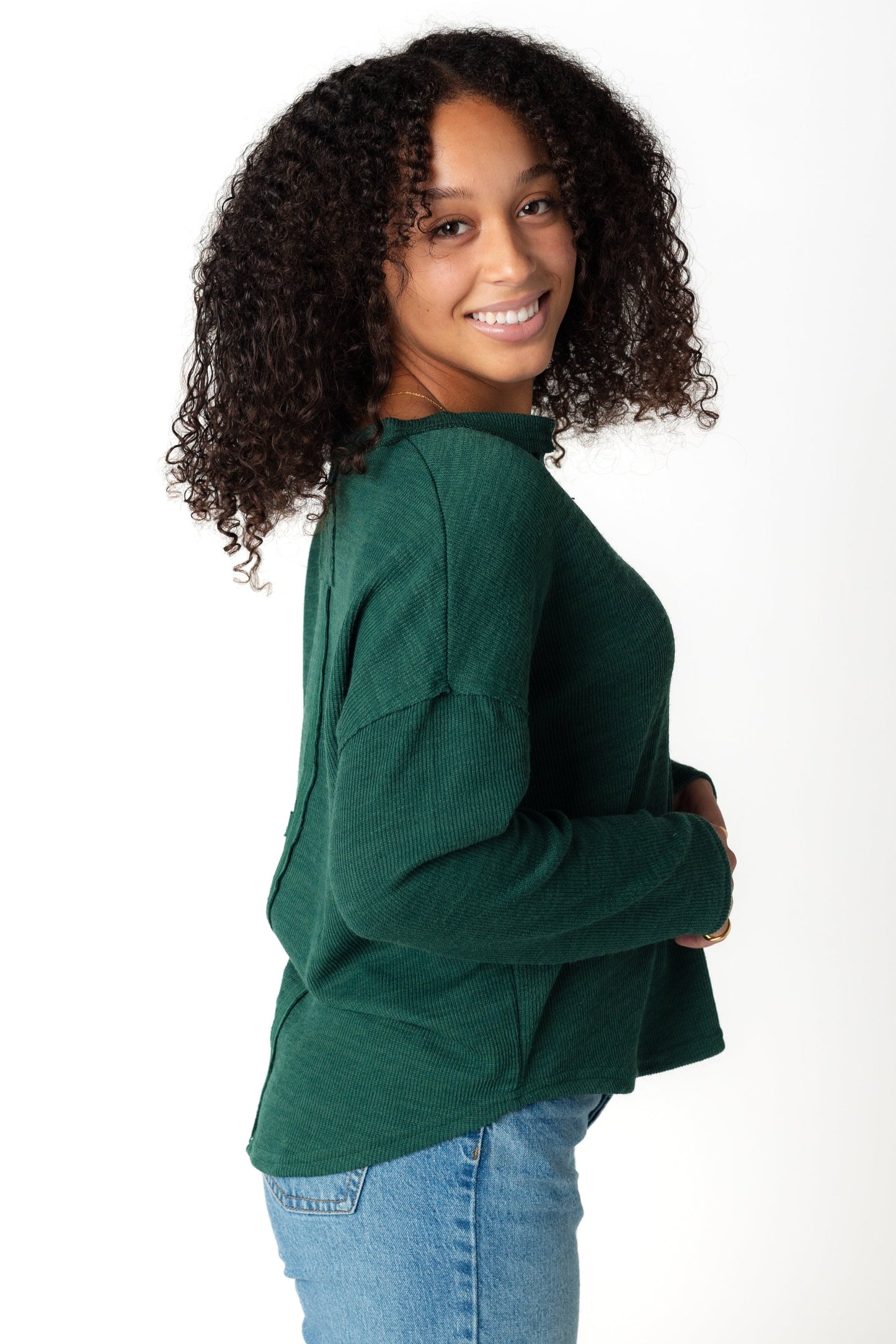 Side view of long sleeve green sweater