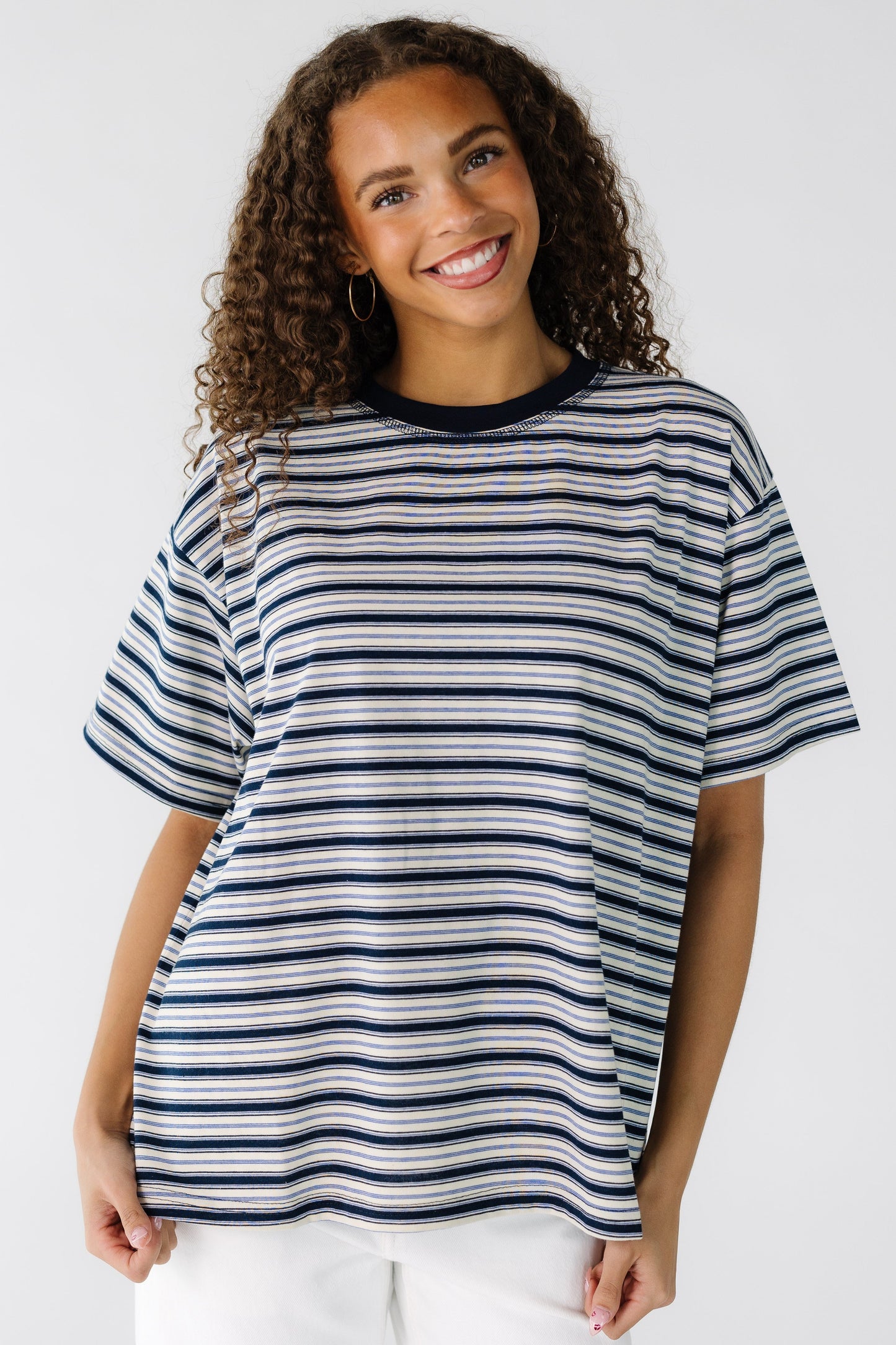 Teenage Girl wearing a modest ivory and navy stripe loose fitting tee with short sleeves.