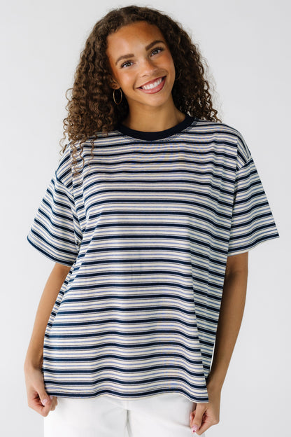 Teenage Girl wearing a modest ivory and navy stripe loose fitting tee with short sleeves.