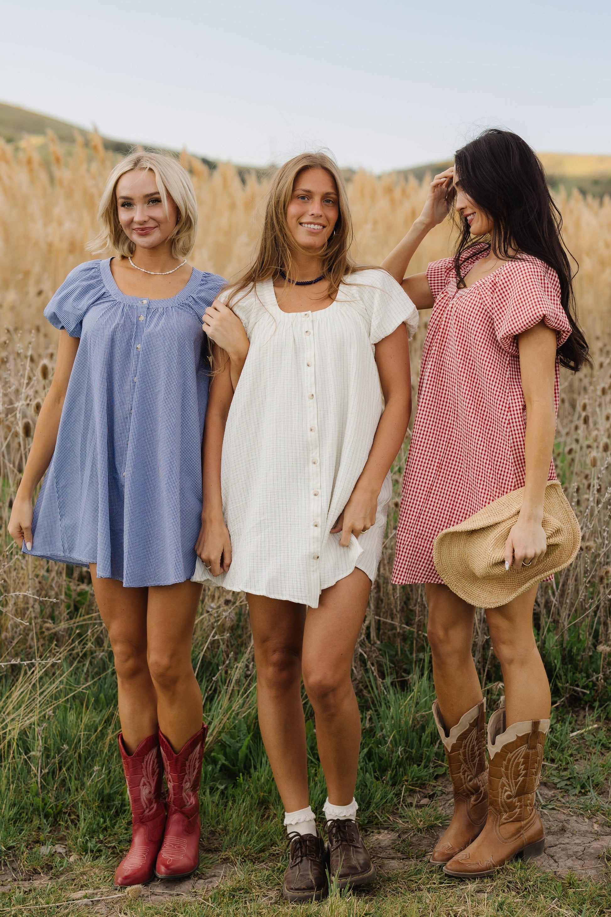Young women wearing the same dress button down dress in 3 different colors and prints.