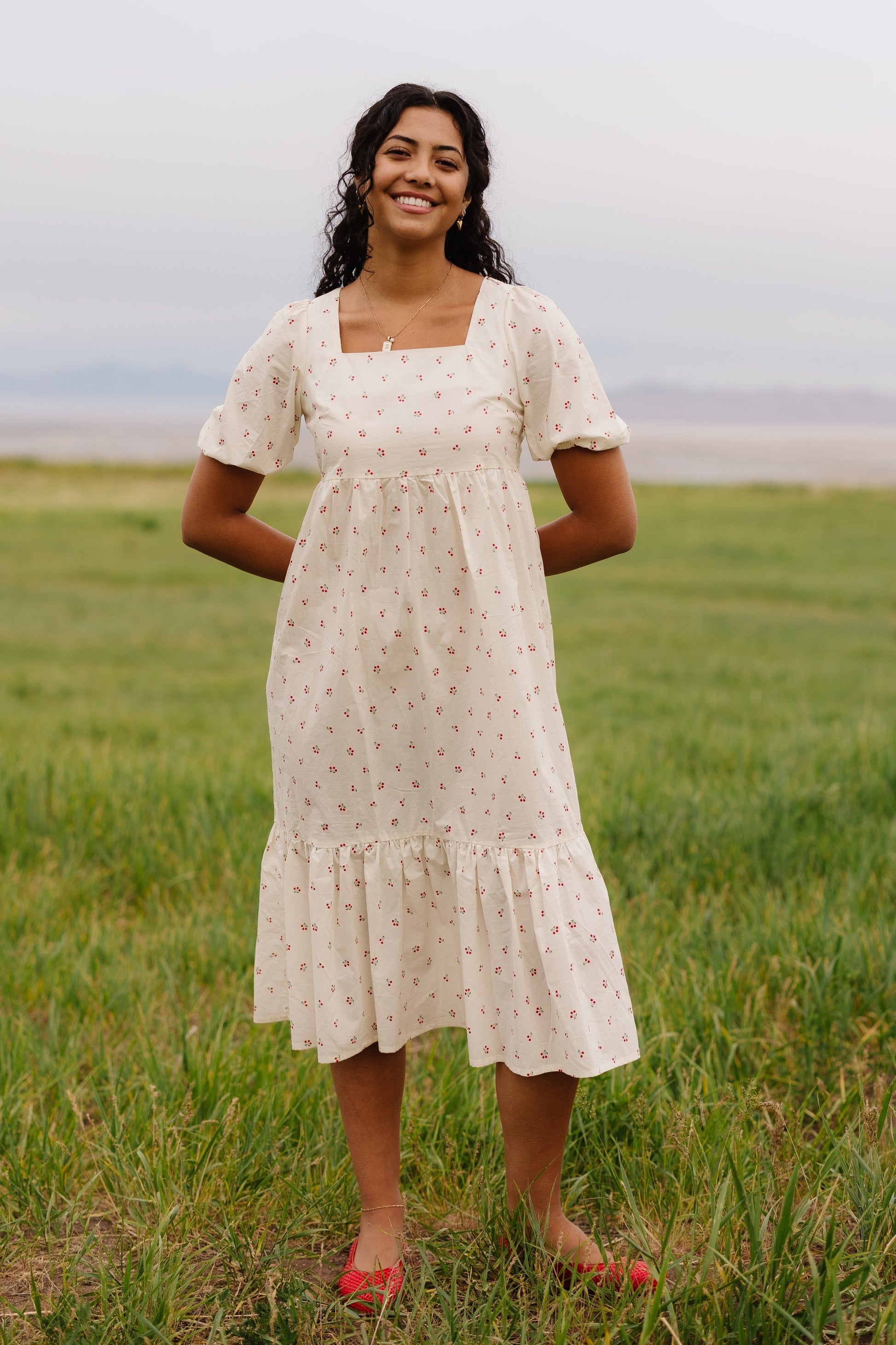 Full view of cherry print midi with short puff sleeves