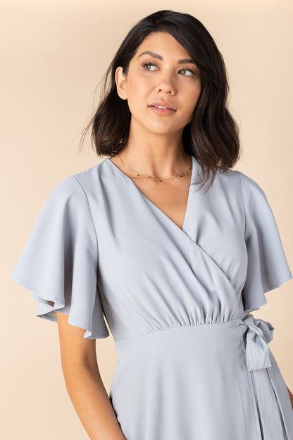 Close view of dusty blue wrap dress with flutter sleeves