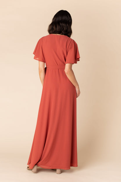 Back view of rust chiffon maxi bridesmaid dress